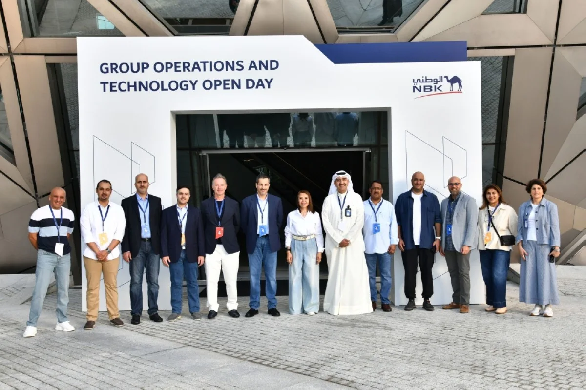 Shaikha Al-Bahar pose for a group photo with the Group Operations and Technology team at the NBK.