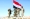 مقاتلون يرفعون علم اليمن أعلى جبل القناصين في نهم عقب تطهيره                                                                                        (تويتر)