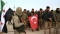 



مرتزقة سوريون يحملون العلم التركي             (مكة)