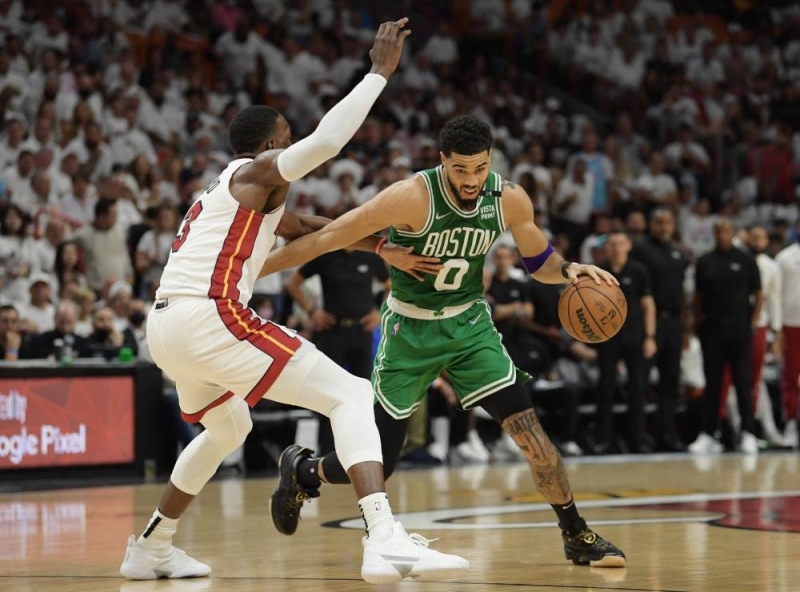 Boston Celtics forward Jayson Tatum (0) drives to the basket against Miami Heat centre Bam Adebayo (13) at the FTX Arena in Miami May 29, 2022. — Reuters pic
