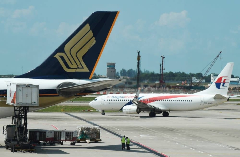 File picture of Malaysia Airlines and Singapore Airlines planes at Changi Airport in Singapore, July 5, 2019. — Reuters pic