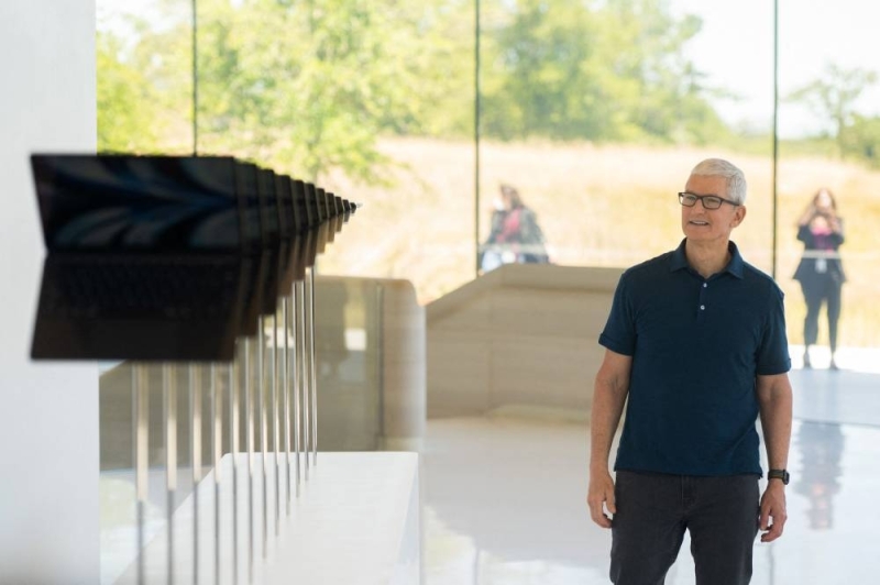 Apple CEO Tim Cook walks along a line of new MacBook Air computers as he enters the Steve Jobs Theater during the 2022 Apple Worldwide Developers Conference (WWDC), June 6, 2022 at the Apple Park campus in Cupertino, California. — AFP pic 