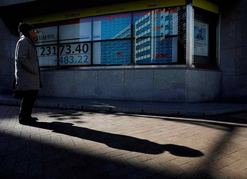 A man looks at a board showing stock prices outside a brokerage in Tokyo, Japan January 6, 2020. — Reuters pic