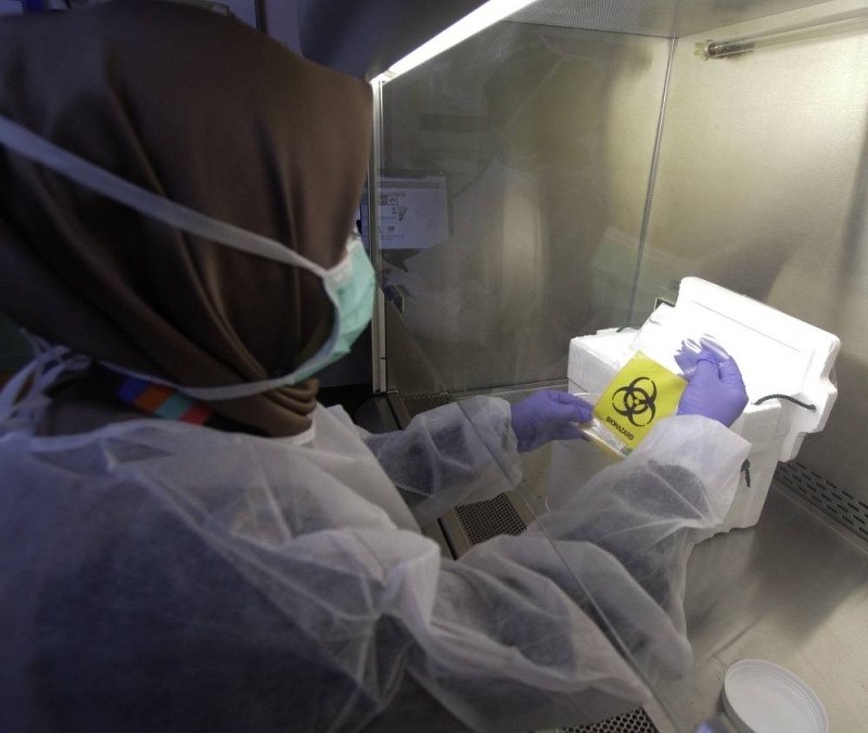 A lab technician processes a test sample during a screening process for the Covid-19 virus, at the Institute for Medical Research in Kuala Lumpur February 26, 2020. — Bernama pic