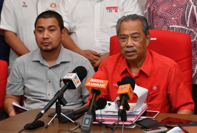 File photo of Datuk Dr Sahruddin Jamal and Tan Sri Muhyiddin Yassin addressing a press conference in Muar October 4, 2019. — Bernama pic