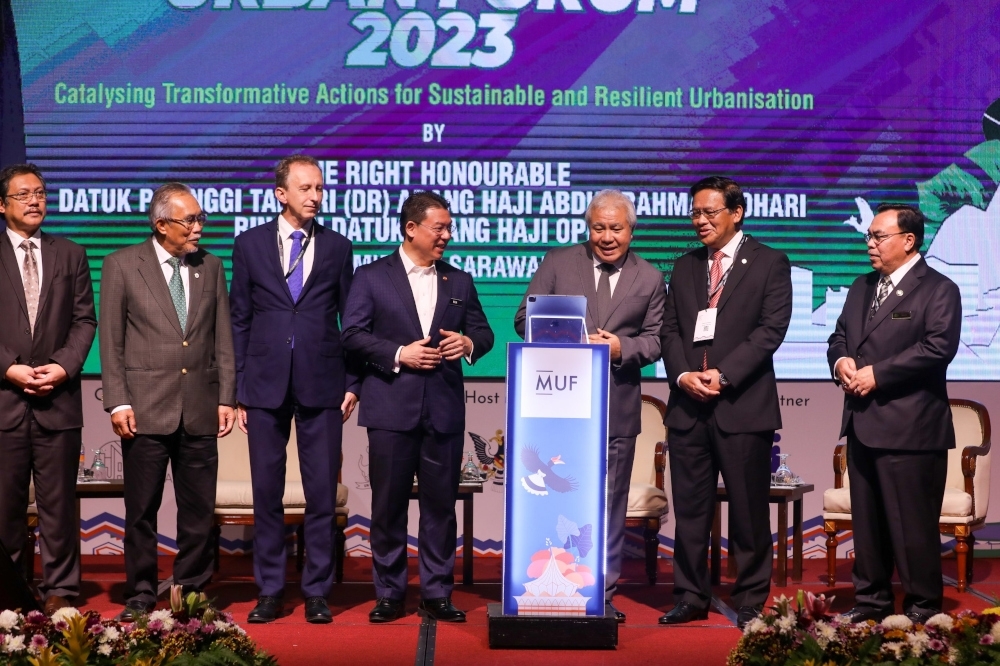 Datuk Awang Tengah Ali Hasan has his face scanned to launch MUF 2023 flanked by Nga Kor Ming and Datuk Dr Abdul Rahman Junaidi. From left are Datuk Dr Hazland Abang Hipni and Datuk Len Talif Salleh. — Borneo Post pic