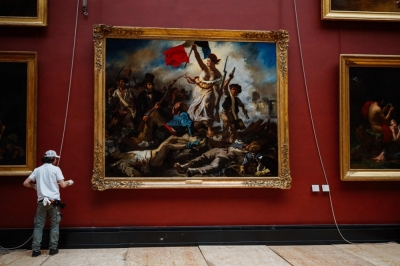 Iconic French painting to make comeback in true colours Employees of the Louvre Museum install the painting ‘Liberty Leading the People’ (1830) by French artist Eugene Delacroix (1798-1863) back on its original spot after its restoration inside the Louvre Museum in Paris, on April 30, 2024. — AFP pic