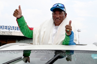 Everest? All in a day’s work for record climber Kami Rita Sherpa Nepali mountaineer Kami Rita Sherpa, who broke his own record for scaling Mount Everest for the 30th time, gestures to the crowd upon his arrival at the Tribhuvan International airport in Kathmandu May 24, 2024. — AFP pic