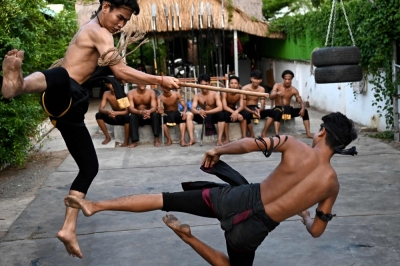 Young Cambodians fight to preserve ancient martial art This photo taken on May 25, 2024 shows ancient Khmer martial art Yutkromkhorm trainee Oeun Bunthav (left) and a colleague performing during a fighting show at a club in Krong Areyksat. — AFP pic