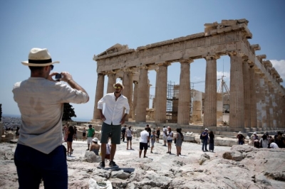 Athens Acropolis €5,000 private tours: A costly experience compared to €20-€30 standard tickets A tourist poses for a picture in front of the ancient Parthenon temple atop Acropolis hill in Athens July 19, 2017. — Reuters pic