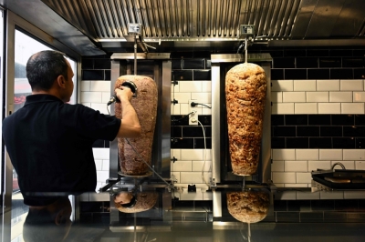 Turkey and Germany in spicy feud over doner kebab An employee scapes meat from a kebab skewer in a Doener restaurant in the city centre of Dortmund July 26, 2024. — AFP pic