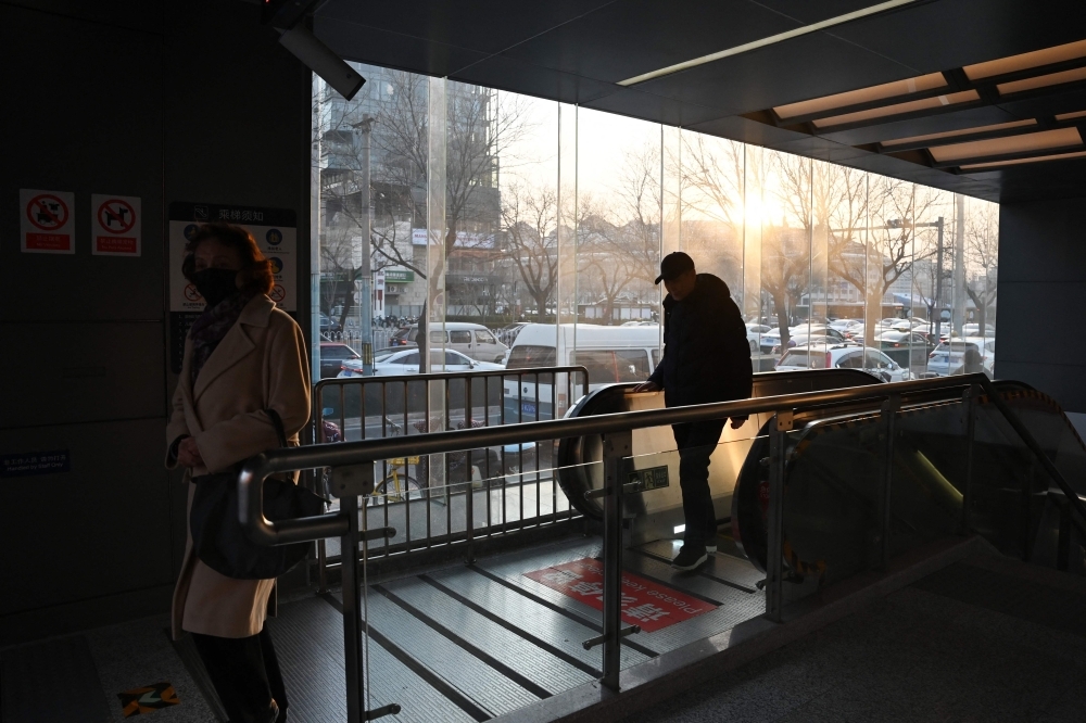 Beijing adds three new metro lines, further easing downtown traffic People exit a metro entrance as the sun sets in Beijing December 11, 2024. The city’s rail transit network currently boasts 522 stations, including 98 interchange stations. — AFP pic