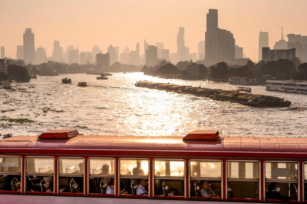 A bus drives on a bridge over the Chao Phraya river amid high air pollution levels in Bangkok on January 21, 2025. — AFP pic A bus drives on a bridge over the Chao Phraya river amid high air pollution levels in Bangkok on January 21, 2025. — AFP pic