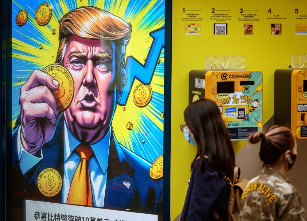US trading partners brace for Trump’s sweeping new tariffs People walk past a cryptocurrency exchange office with a screen featuring US President Donald Trump holding cryptocurrency coins in Hong Kong on March 12, 2025. — File pic via AFP