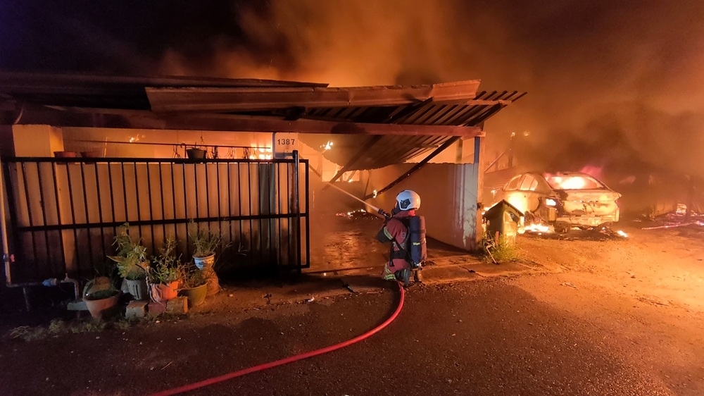 Early morning blaze in Bintulu’s RPR Sebiew destroys six houses, 67 residents displaced, says Sarawak Fire Dept Handout photo shows a firefighter extinguishing flames at one of the affected units at Lorong B5 in RPR Sebiew. — Picture courtesy of the Fire and Rescue Department