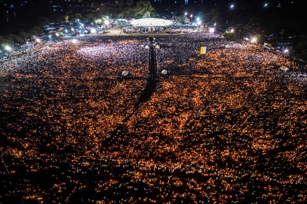 Pope Francis laid to rest as 400,000 mourners honour his legacy ‘with open heart’ An aerial image shows Catholic believers holding candles during Pope Francis? requiem mass at the Esplanade of Tasitolu in Dili, East Timor, where he held a Mass in September last year, on April 26, 2025, as his funeral takes place in Vatican. The funeral for Pope Francis was held yesterday after the 88-year-old reformer died of a stroke on April 21, the Vatican announced. — AFP pic