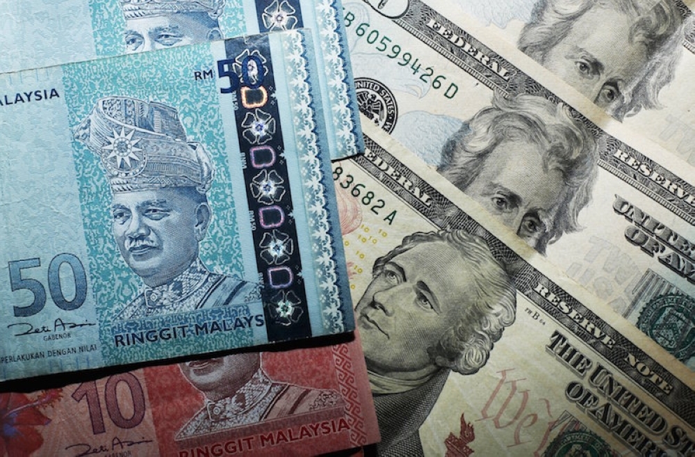 Ringgit weakens as geopolitical tensions boost US dollar safe-haven appeal The ringgit slipped against the US dollar on the final trading day of the week, reversing earlier gains as rising geopolitical concerns drove safe-haven demand for the greenback. — Reuters pic