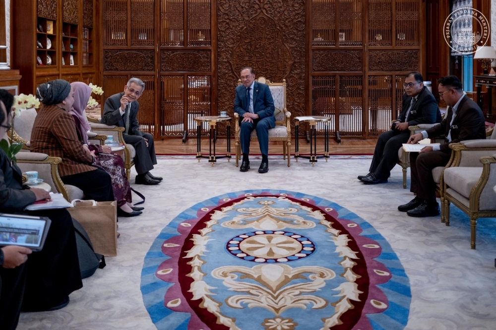 PM wants Suhakam to champion rights in tech era, warns of rising risks to children’s safety Prime Minister Datuk Seri Anwar Ibrahim (centre) holds a discussion with the Suhakam delegation led by its chairman Datuk Seri Mohd Hishamudin Yunus (third from left) in Putrajaya on June 16, 2025. — Picture from Facebook/Anwar Ibrahim