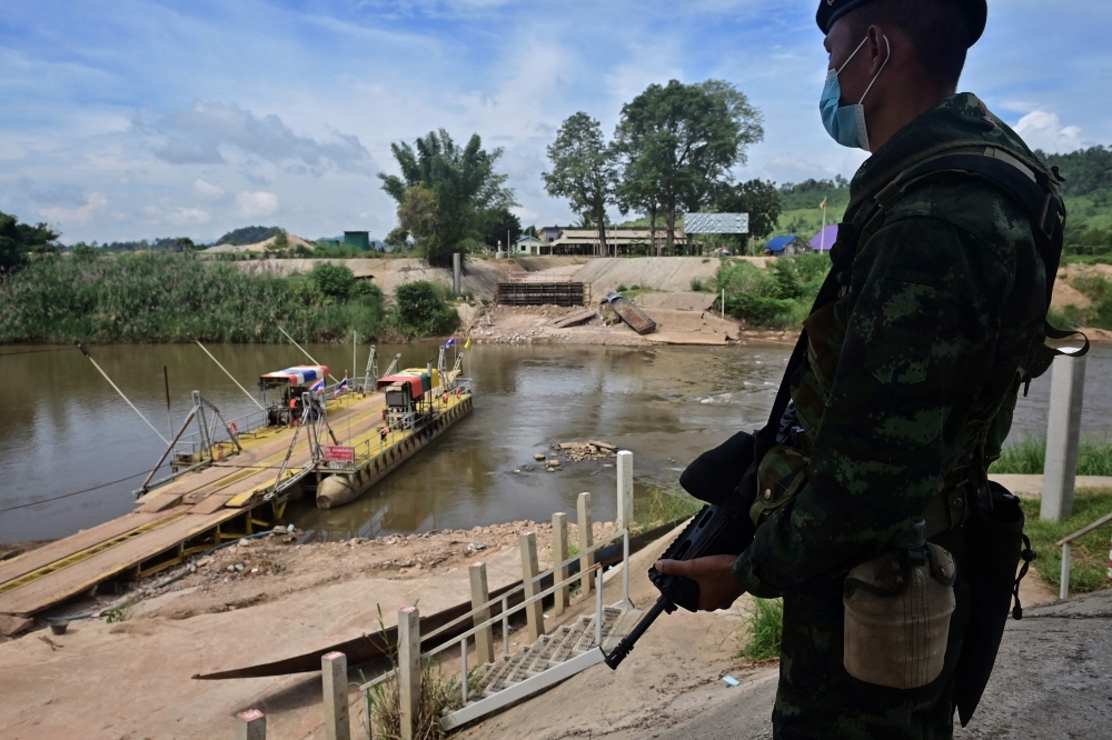 Over 500 Myanmar soldiers, civilians flee into Thailand after assault by ethnic fighters on military base