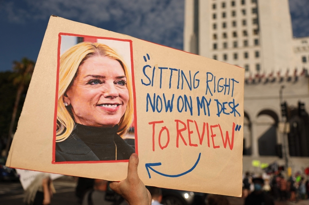 Trump, Epstein, why MAGA is in turmoil: Key facts you need to know A protester holds a sign featuring a photo of US Attorney General Pam Bondi and a quote referencing the Epstein files during a ‘Good Trouble Lives On’ demonstration against the Trump administration in Los Angeles on July 17, 2025. — AFP pic