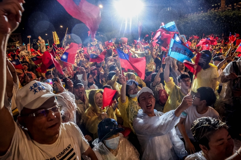 Taiwan holds high-stakes recall vote that could shift control of parliament Supporters of Taiwan's main opposition party, Kuomintang (KMT), participate in a rally amid heavy rain against the recall election in front of the Presidential Office in Taipei yesterday. — AFP pic