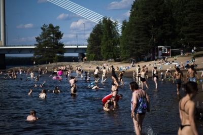 From from Finland to Norway, Nordic ‘coolcations’ ruined as heatwave shatters records  Picture taken on July 23, 2025 shows people bathing at the Ounaskoski Beach at the Arctic Circle in Rovaniemi, Finnish Lapland. — AFP pic