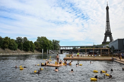 Seine sees record turnout as thousands of Parisians brave rain to swim in cleaned-up river People swim at the Grenelle safe bathing site on the Seine river on its opening day, in front of the Eiffel Tower in Paris on July 5, 2025. — AFP pic
