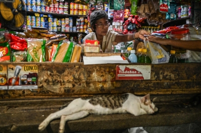 Searching for lost fathers: Filipino man reunites with Japanese family after 82 years, while another finds her own identity In this photo taken on August 8, 2025, Maria Corazon Nagai attends to her grocery store at a market in Manila. — AFP pic