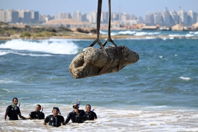 Lost city resurfaces: Egypt unveils 2,000-year-old sunken ruins off Alexandria coast Divers watch as a crane pulls a piece of stone from the waters at Abu Qir bay in Alexandria on August 21, 2025, as part of an event organised by the Ministry of Tourism and Antiquities to recover sunken antiquities. — AFP pic