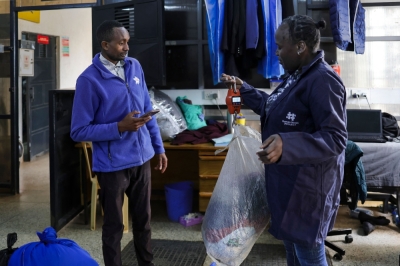 ‘Restoring dignity’: Kenya slum exchange offers water for plastic A resident uses digital credit earned from delivering plastic waste to a Human Needs Project (HNP) collection point to pay for laundromat services in the Kibera informal settlement of Nairobi, on August 11, 2025. — AFP pic