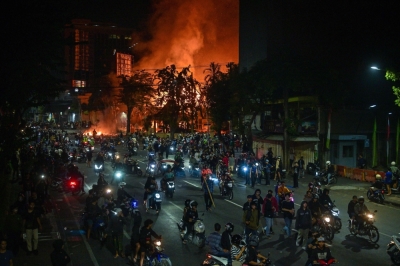 Tense streets: Indonesia boosts security after fatal protests over lawmaker perks Protesters rides motorcycles in front of a police headquarters that was burned and looted during demonstrations in Surabaya August 31, 2025. — AFP pic
