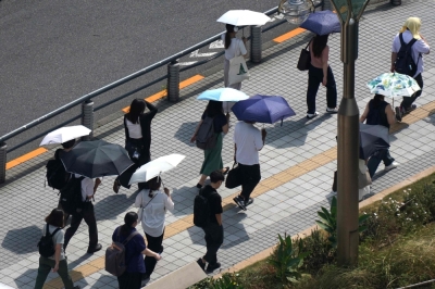 UK, Japan and South Korea record hottest summers in history amid climate crisis People with umbrellas walk in the scorching sun in Tokyo. — AFP pic