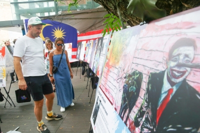 By its river, a nation dreams of 2050 Tourists and locals give a long look at how tall tales grow taller, at the Bersama2050 Exhibition, at the river of life. — Picture by Choo Choy May