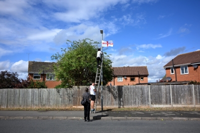 Symbol of unity or division? Why English flags are flooding towns and cities across the UK A member of the Worcester Patriots ties a St Georges Cross flag onto a streetlamp in Worcester, north west England September 3, 2025. — AFP pic