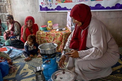 Cooking classes with cheap recipes help Pakistani mothers fight child malnutrition This photograph taken on July 29, 2025 shows a female health worker (right) teaching mothers how to prepare nutritious meals for their children during a Unicef nutrition programme at Fateh Muhammad Soomro village in the Sujawal district of Sindh province. — AFP  pic