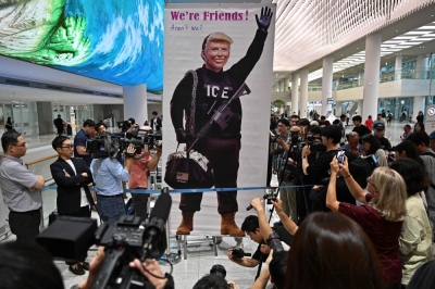South Korean outrage grows as arrested workers fly home after US crackdown A protester displays a banner with a depiction of US President Donald Trump at Incheon International Airport in Incheon on September 12, 2025. — AFP pic
