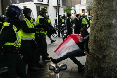 ‘Violence is coming’: Musk’s shock speech ignites chaos at Britain’s largest far-right rally A supporter of British far-right activist Tommy Robinson scuffles with police officers during a “Free speech” march in central London on September 13, 2025. — AFP pic
