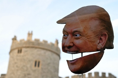 ‘Say it loud, say it clear’: Thousands protest Trump’s UK visit as Windsor pageantry unfolds A demonstrator holds a placard of the US President's face during a protest against the forthcoming State Visit of US President Donald Trump, outside Windsor Castle in Windsor on September 16, 2025. — AFP pic