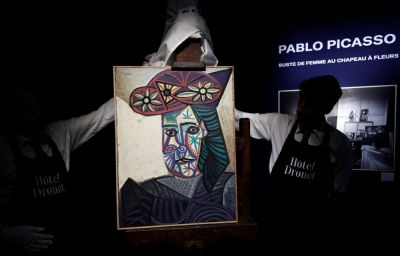 ‘Quite exceptional’: Previously unknown Picasso portrait unveiled in Paris Employees unveal a painting by French artist Pablo Picasso titled ‘Bust of a woman wearing a flowered hat’ and featuring Dora Maar, during its presentation at Hotel Drouot auction house on September 18, 2025. — AFP pic