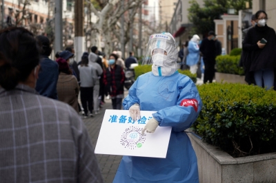 ‘Information hero’ Zhang Zhan sentenced to four more years over Covid-19 reporting in China A worker in a protective suit shows a QR code to residents lining up for nucleic acid testing, as the second stage of a two-stage lockdown to curb the spread of Covid-19 begins in Shanghai April 1, 2022. — Reuters pic