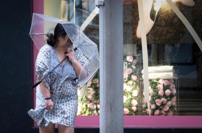 McDonald’s and some ‘cha chaan teng’ brave Ragasa to keep doors open and hot meals coming in Hong Kong A woman holds an umbrella as she battles gusts of wind as Super Typhoon Ragasa hits Causeway Bay district in Hong Kong September 24, 2025. — AFP pic