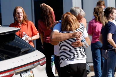 Four dead in Michigan church attack as Trump warns of ‘epidemic of violence’ People hug near the reunification area outside of the NCG Cinema - Grand Blanc Trillium near the scene of a shooting at a church in Grand Blanc, Michigan, on September 28, 2025. — AFP pic