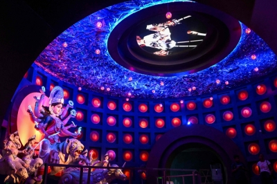 Kolkata’s Durga Puja embraces AI as artisans blend ancient rituals with futuristic designs Visitors stand inside a 'Pandal' (temporary place for worship) next to an idol of the Hindu Goddess Durga, decorated with the theme of Artificial Intelligence (AI), in Kolkata on September 24, 2025, ahead of the Durga Puja festival. — AFP pic