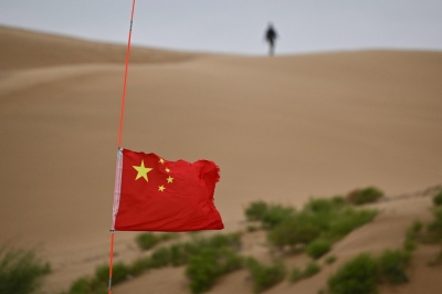 Turning deserts green and lives upside down: Inside China’s massive rewilding project This picture taken on August 12, 2025 shows a Chinese flag fluttering between the green zone and the desert landscape of the Kubuqi Desert near Ordos. — AFP pic
