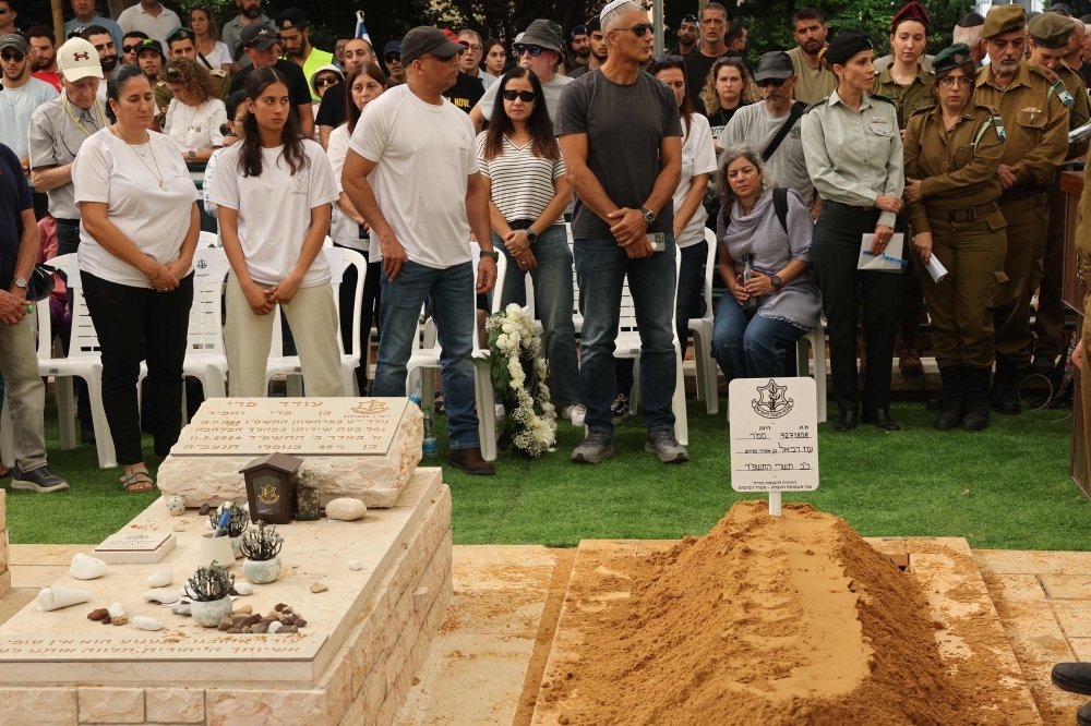 Israel recovers hostage remains from Gaza as ceasefire handovers continue Relatives and friends of Oz Daniel, a 19-year-old Israeli corporal who was killed by Palestinian militants in the October 7, 2023 attacks on southern Israel and whose body was taken to Gaza, attend his funeral at the military cemetery in Kfar Saba on November 6, 2025. — AFP pic
