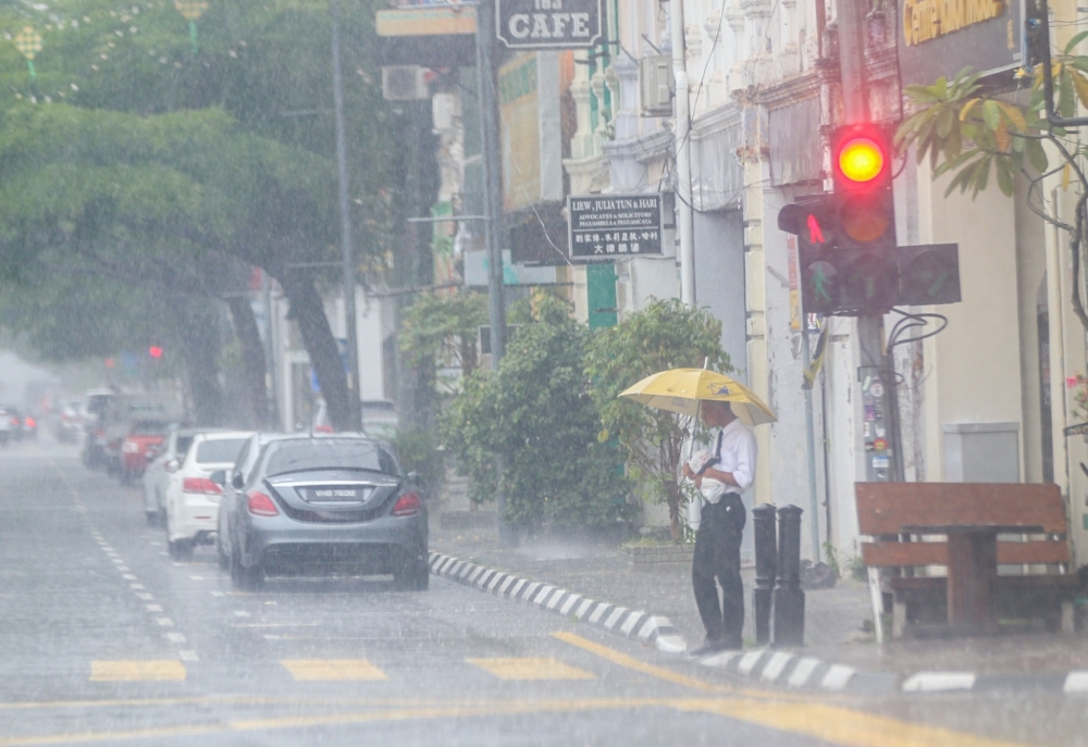 Extended wet spell forecast across Malaysia with risk of strong winds and heavy rain Heavy rain is seen in Ipoh, Perak on May 16, 2022. — Picture by Farhan Najib