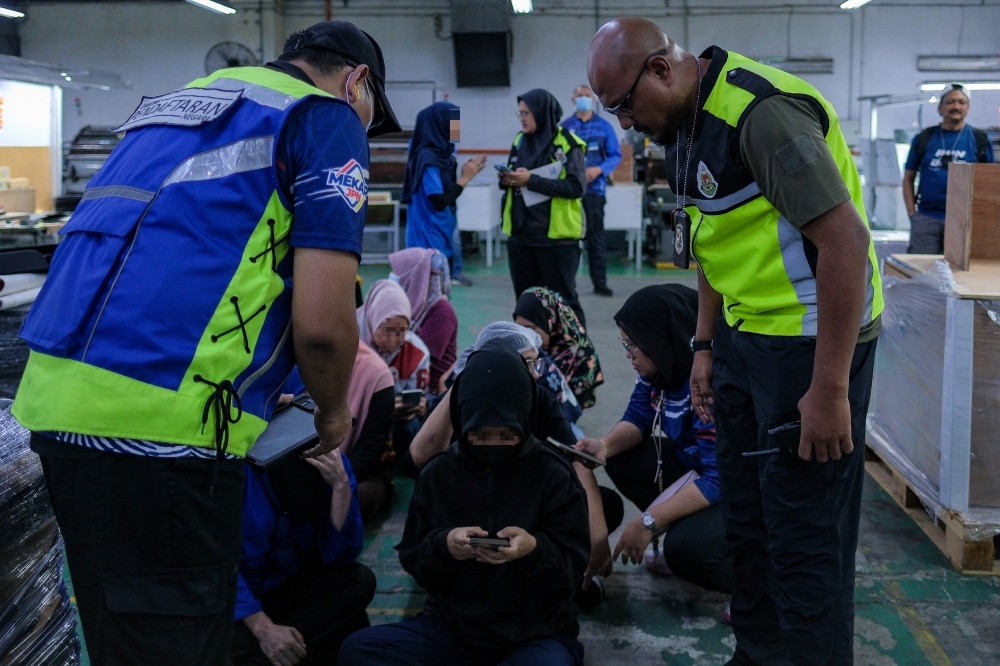 Underage workers exposed: 31 minors, including a 14-year-old, caught using family members’ ID cards in Johor Officers from the National Registration Department (NRD) together with the Malaysian Immigration Department (JIM) conduct inspections of local and foreign workers during Ops Kotak at a box-making and printing factory in Johor Technology Park, Senai, November 17, 2025. — Bernama pic