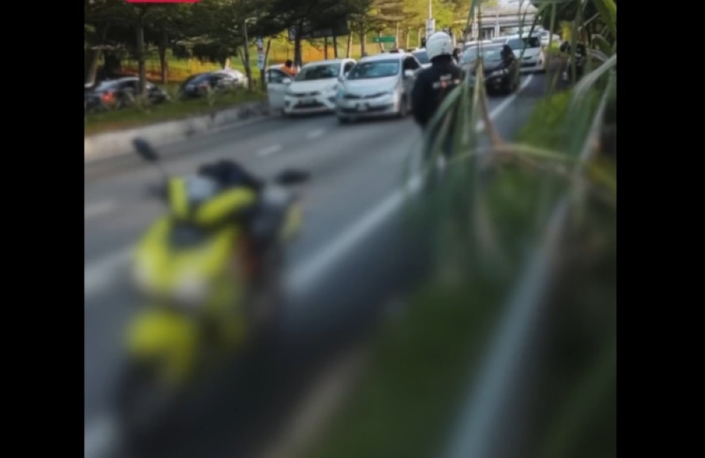 Seremban gun attack along Jalan Rasah: One dead, another hospitalised in suspected gang feud The incident, captured by a member of the public, showed a man slumped in the driver’s seat of a white Perodua Myvi. — Picture from social media