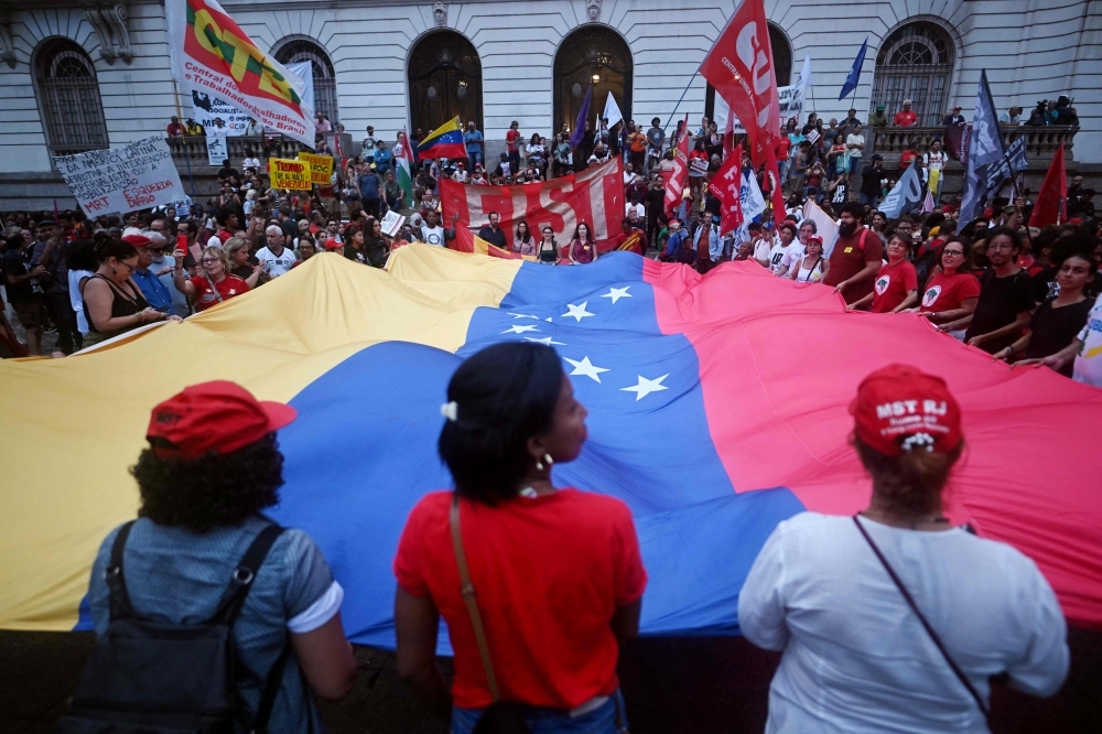 ‘Nobody is going to run home’: Venezuelan diaspora in wait-and-see mode People display a giant Venezuelan flags as they take part in a demonstration in support of Venezuela’s President Nicolas Maduro at the Cinelandia square in Rio de Janeiro, Brazil, on January 5, 2026, after US forces captured Venezuelan leader Nicolas Maduro. — AFP pic