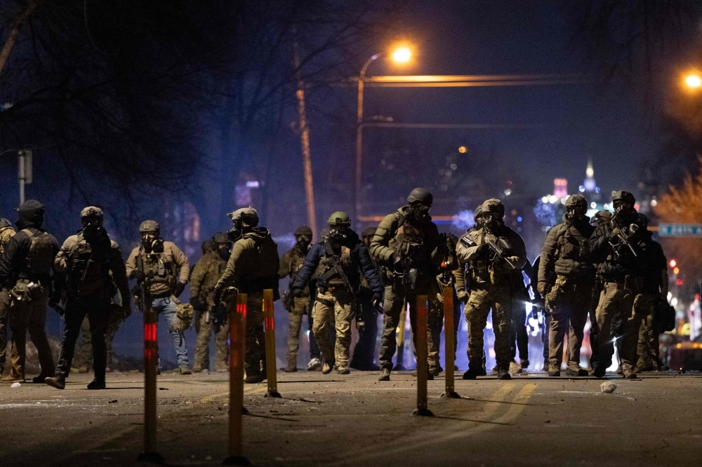 Pentagon orders 1,500 troops on standby for possible Minnesota deployment Federal agents guard a perimeter following a shooting incident as angry residents protest their presence in the city on January 14, 2026 in Minneapolis, Minnesota. — AFP pic